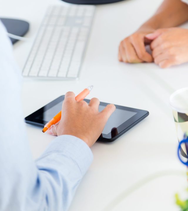 two business woman working in office with digital tablet.